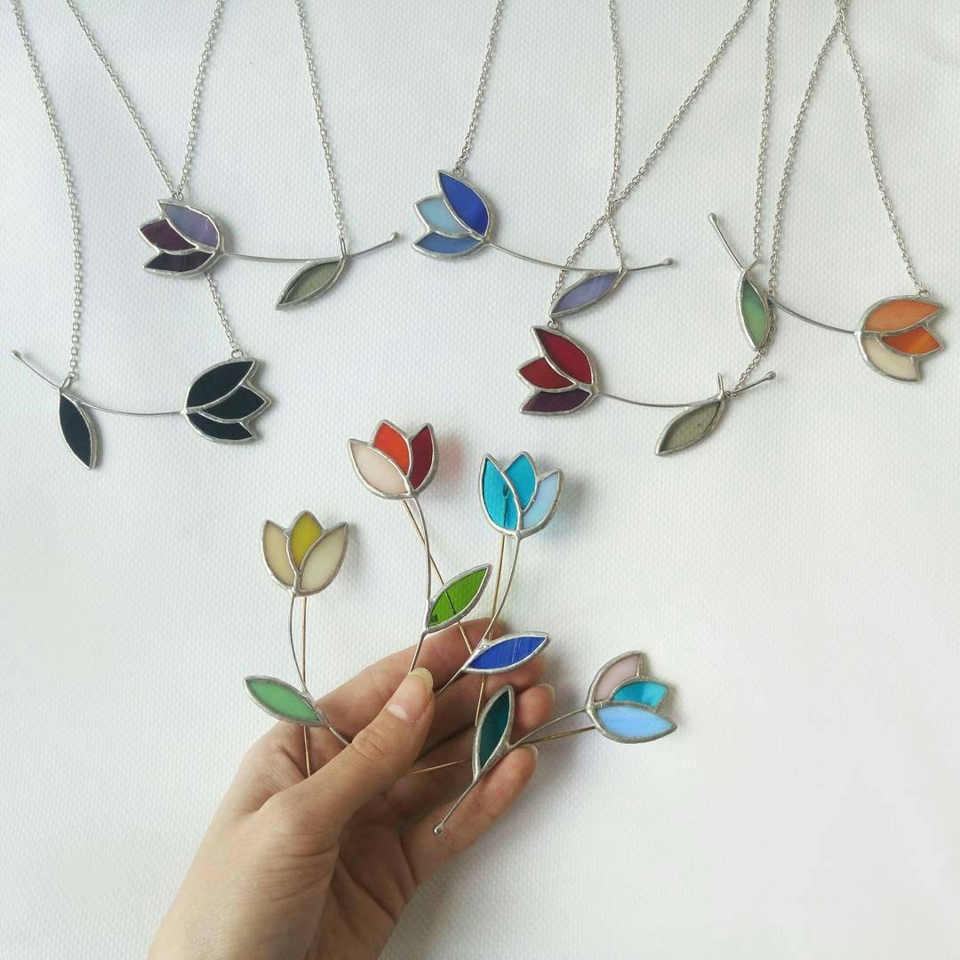 Tulip stained glass brooch held in hand