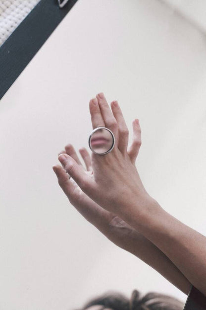 Massive silver ring with a mirror disc in a modern geometric style