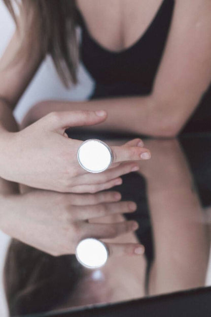 Large handmade mirror ring, modern architectural design on model's hand
