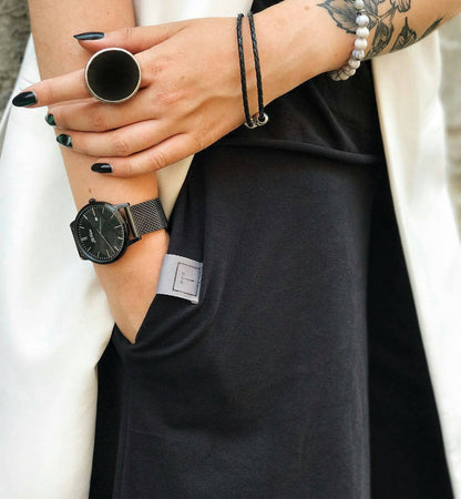 Black round ring styled with black outfit, minimalist gothic fashion