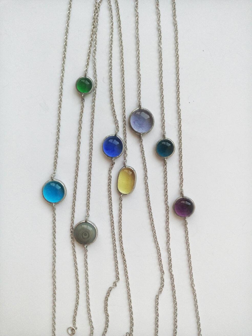 Handmade stained glass orb pendants in multiple colors on chains