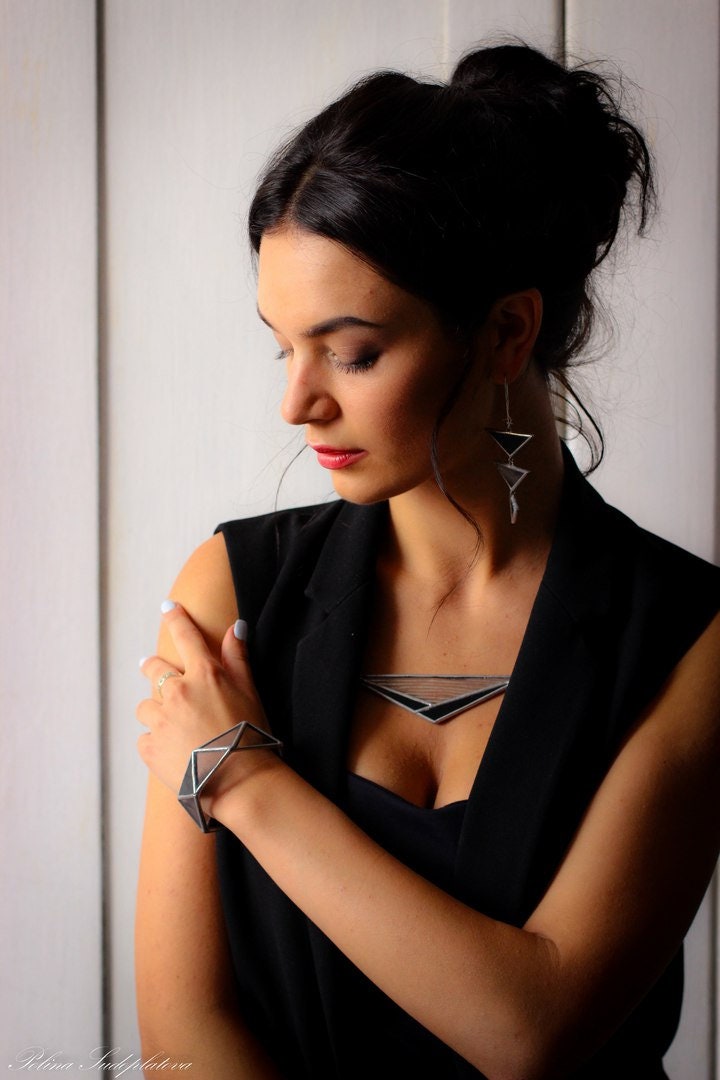 Model wearing black geometric statement necklace