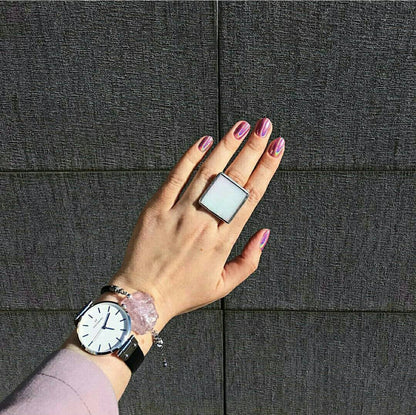 Chunky geometric white statement ring close up