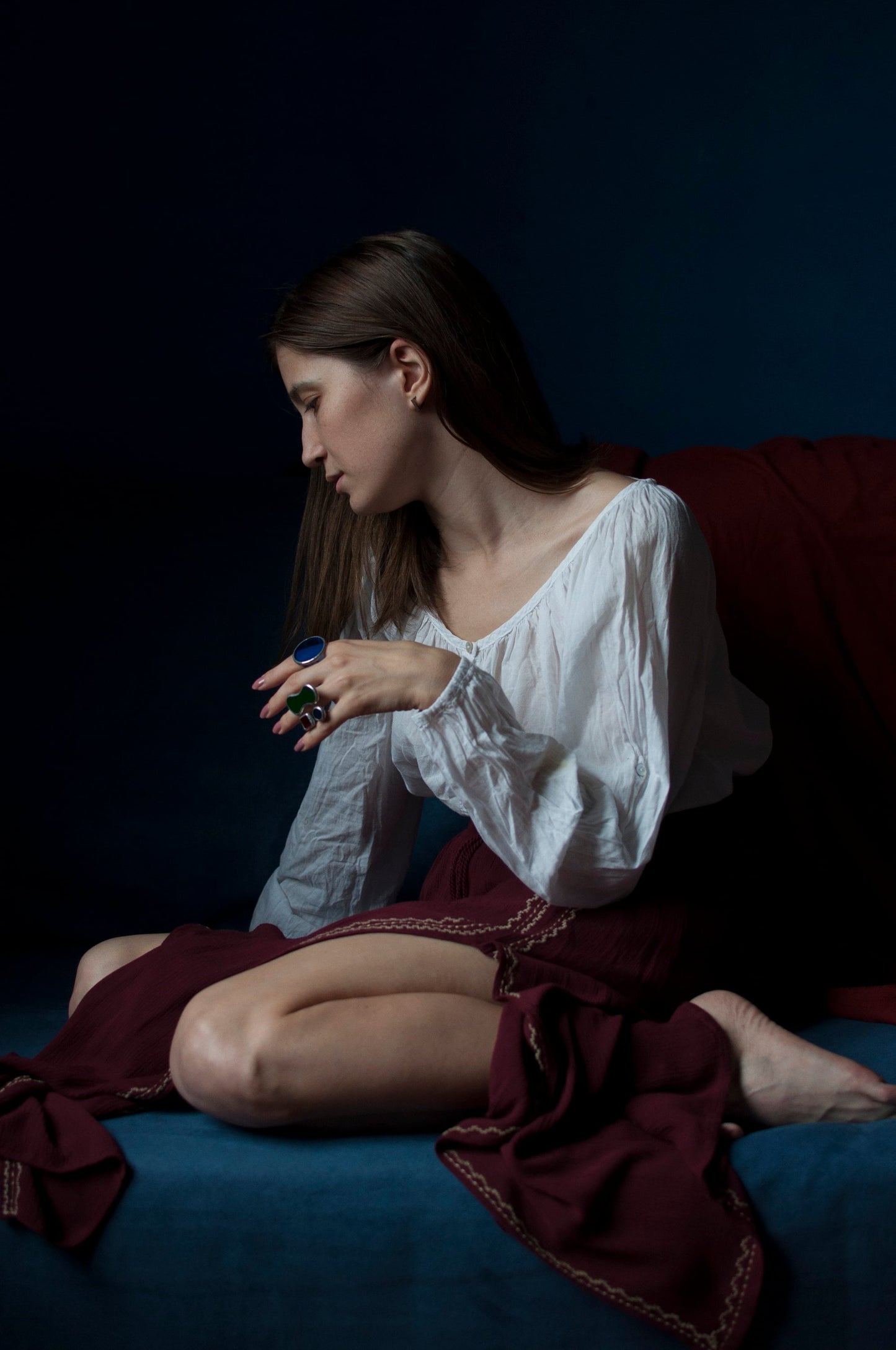 Woman wearing colorful stained glass ring with artistic style, large geometric jewelry on finger