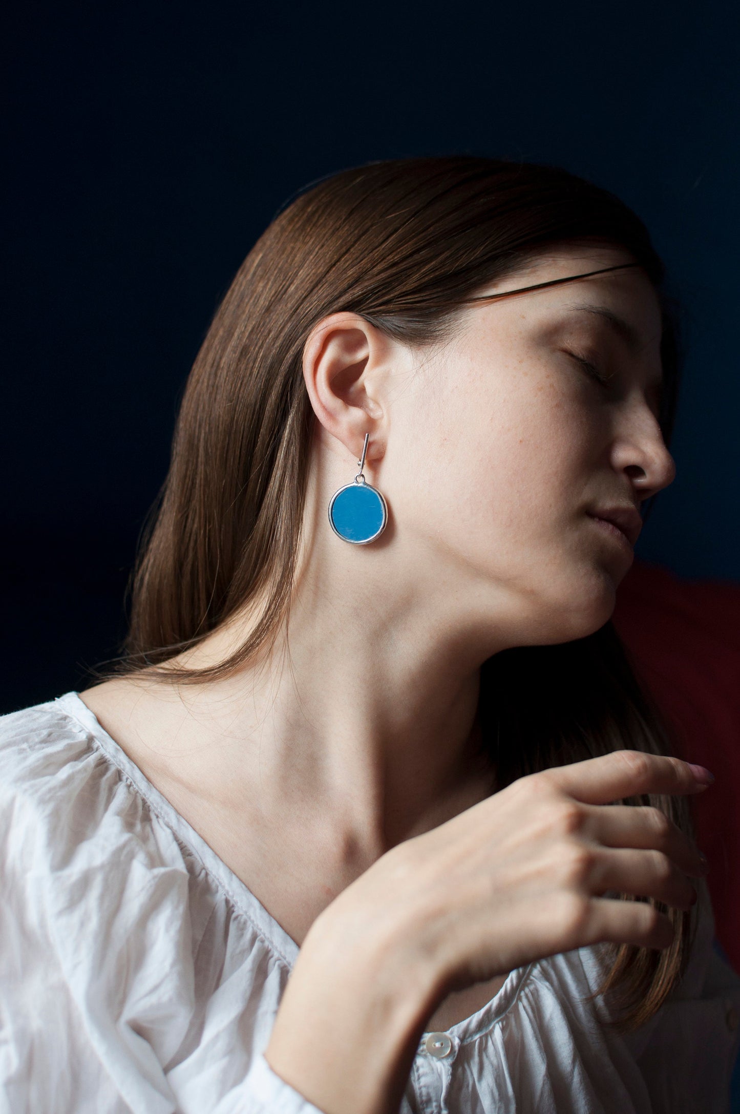 Elegant mirrored earrings in the style of minimalism, close-up