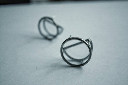 Close-up of transparent double disc earrings on white background