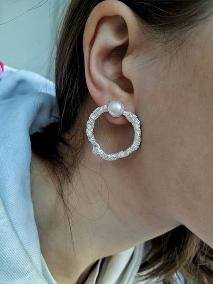 Handcrafted silver hoop earrings close-up
