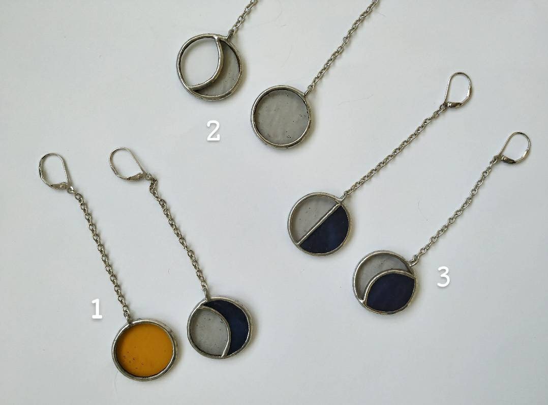 Celestial stained glass earrings with long silver chains flat lay