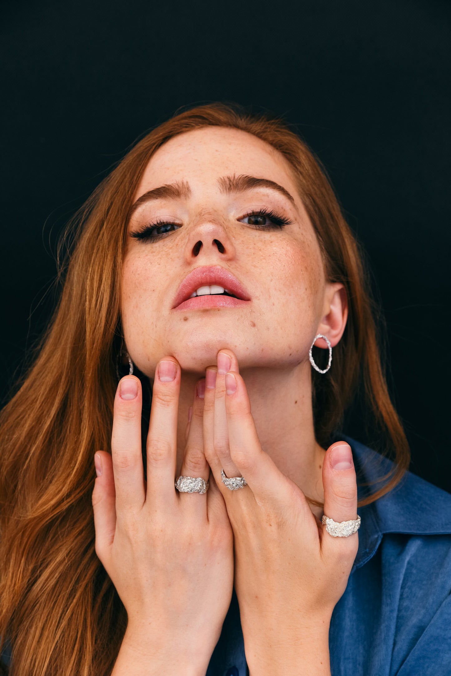 Woman showing silver mountain ring set