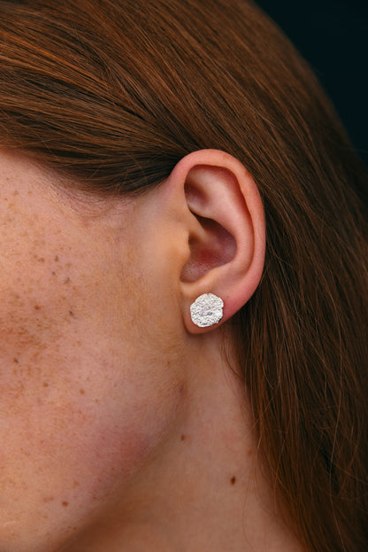 molten textured silver earrings close up