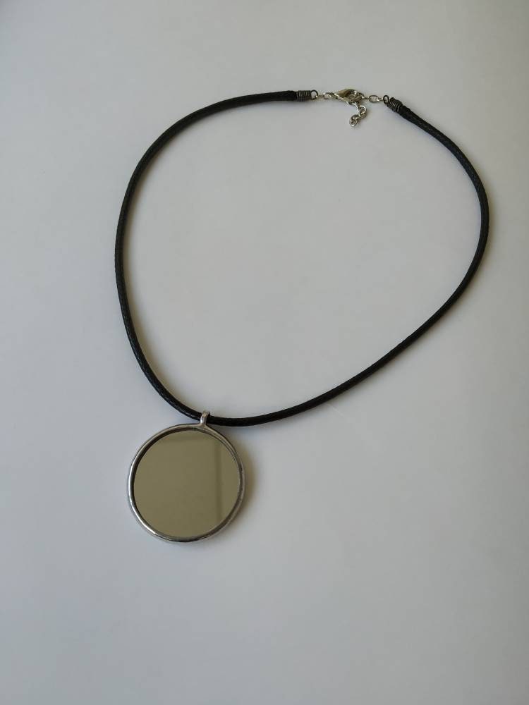 Flat lay of mirror pendant on white background