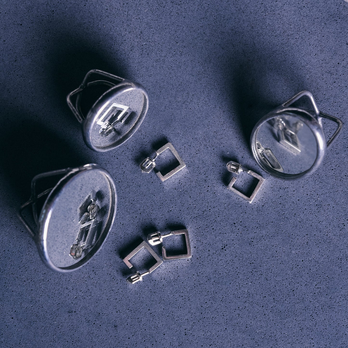 silver jewelry set on blue backdrop