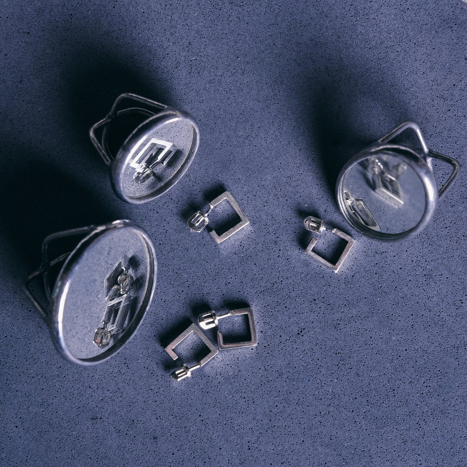 silver jewelry set on blue backdrop
