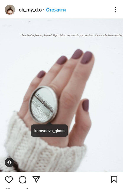 Large round handmade mirror ring reflects the sea coast