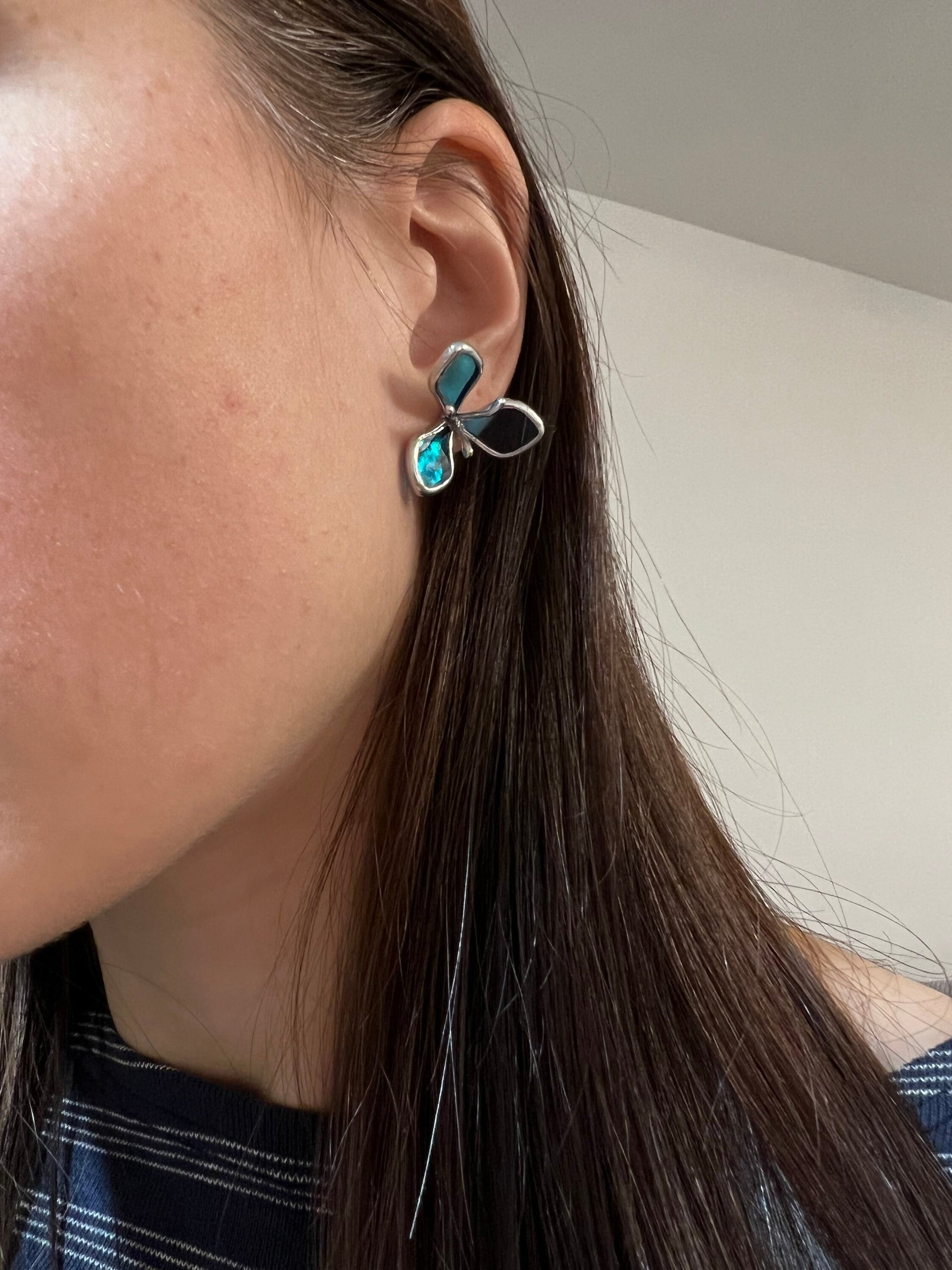 Blue hydrangea stained glass earring close-up on model