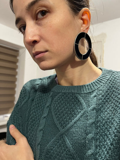 Side view of stained glass hoop earrings, bold black design
