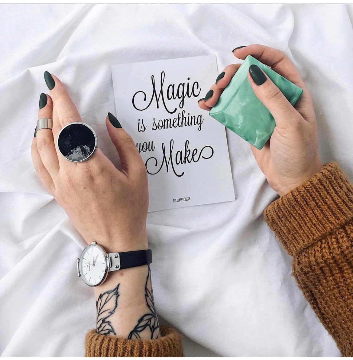 Large black geometric ring on female hand, modern statement jewelry