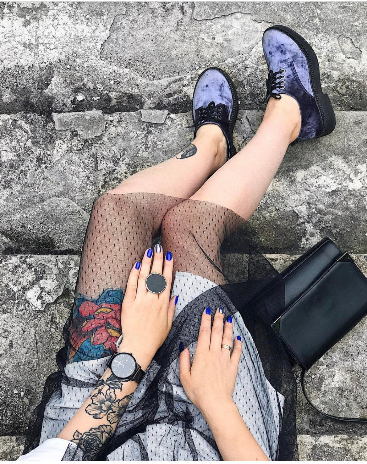 Chunky black disc ring worn outdoors, bold architectural jewelry