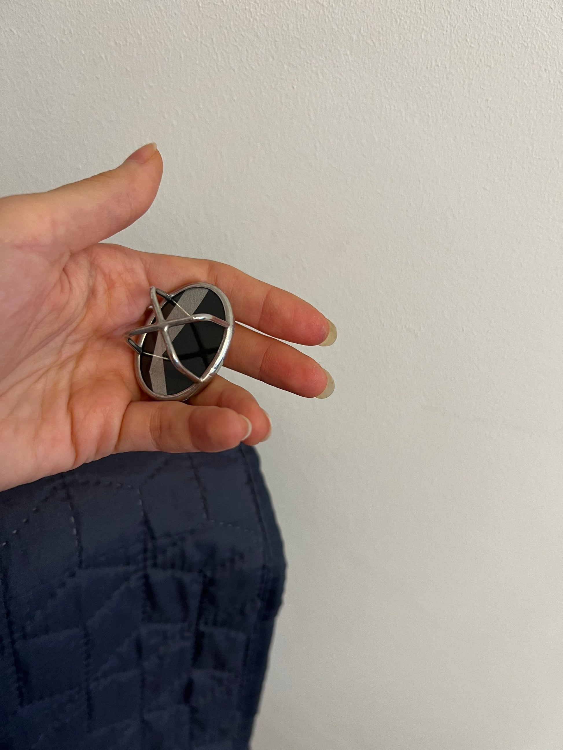 Geometric oval mirror ring silver stained glass close-up