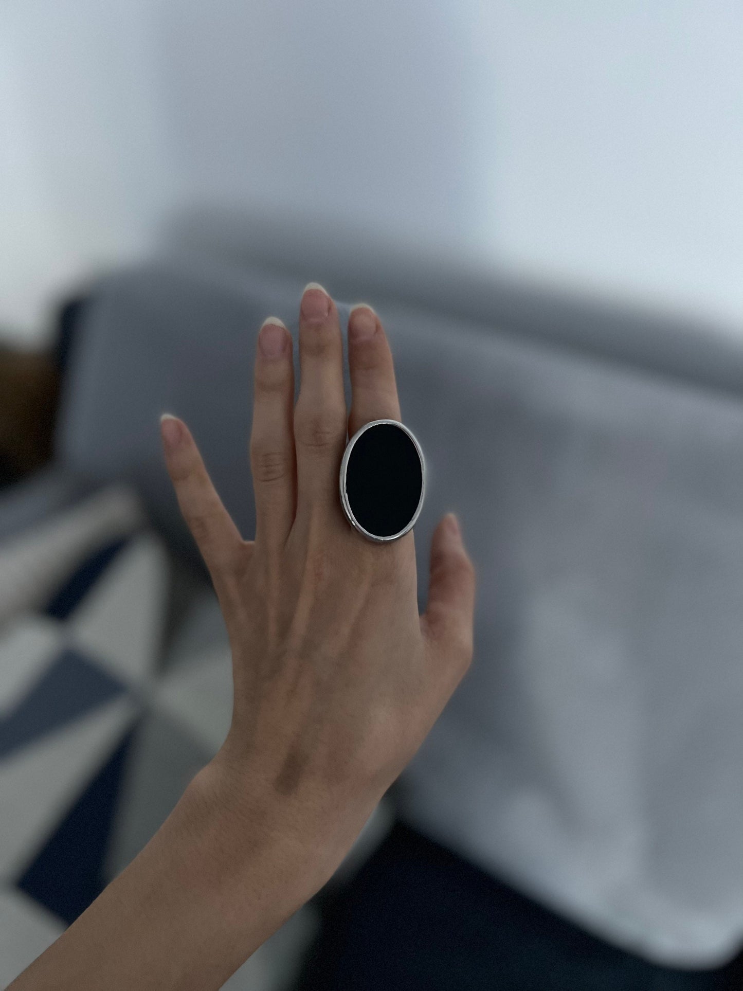 black oval ring on a woman's hand
