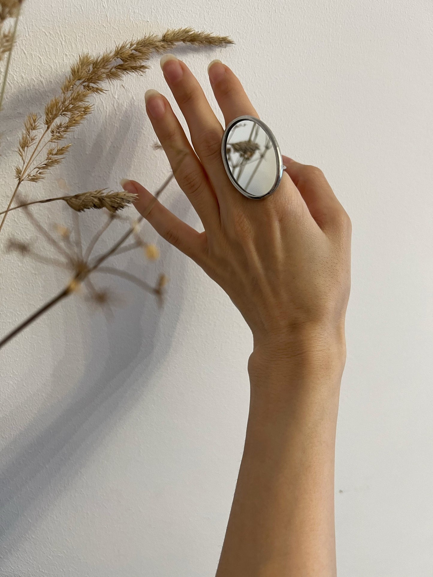 Oval mirror ring on hand, bold stained glass statement jewelry