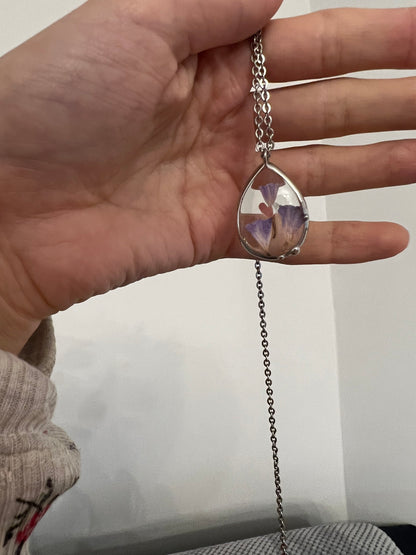 Teardrop flower necklace shown in hand for size reference