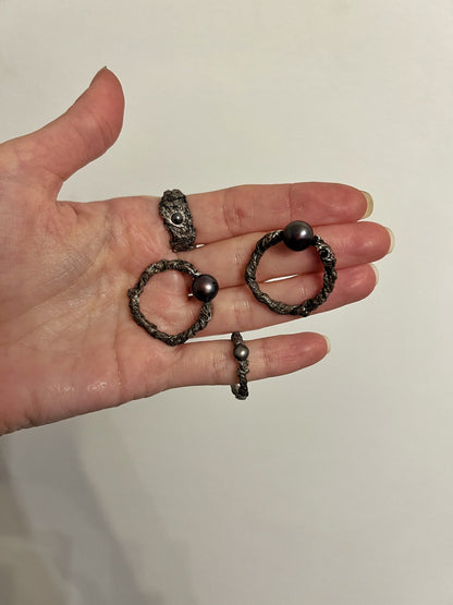 Dark silver hoops with pearl on model close-up
