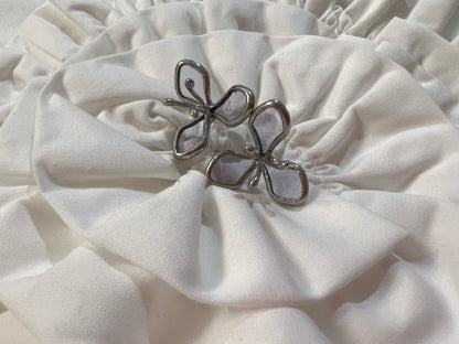 Light purple stained glass flower earrings on white cloth