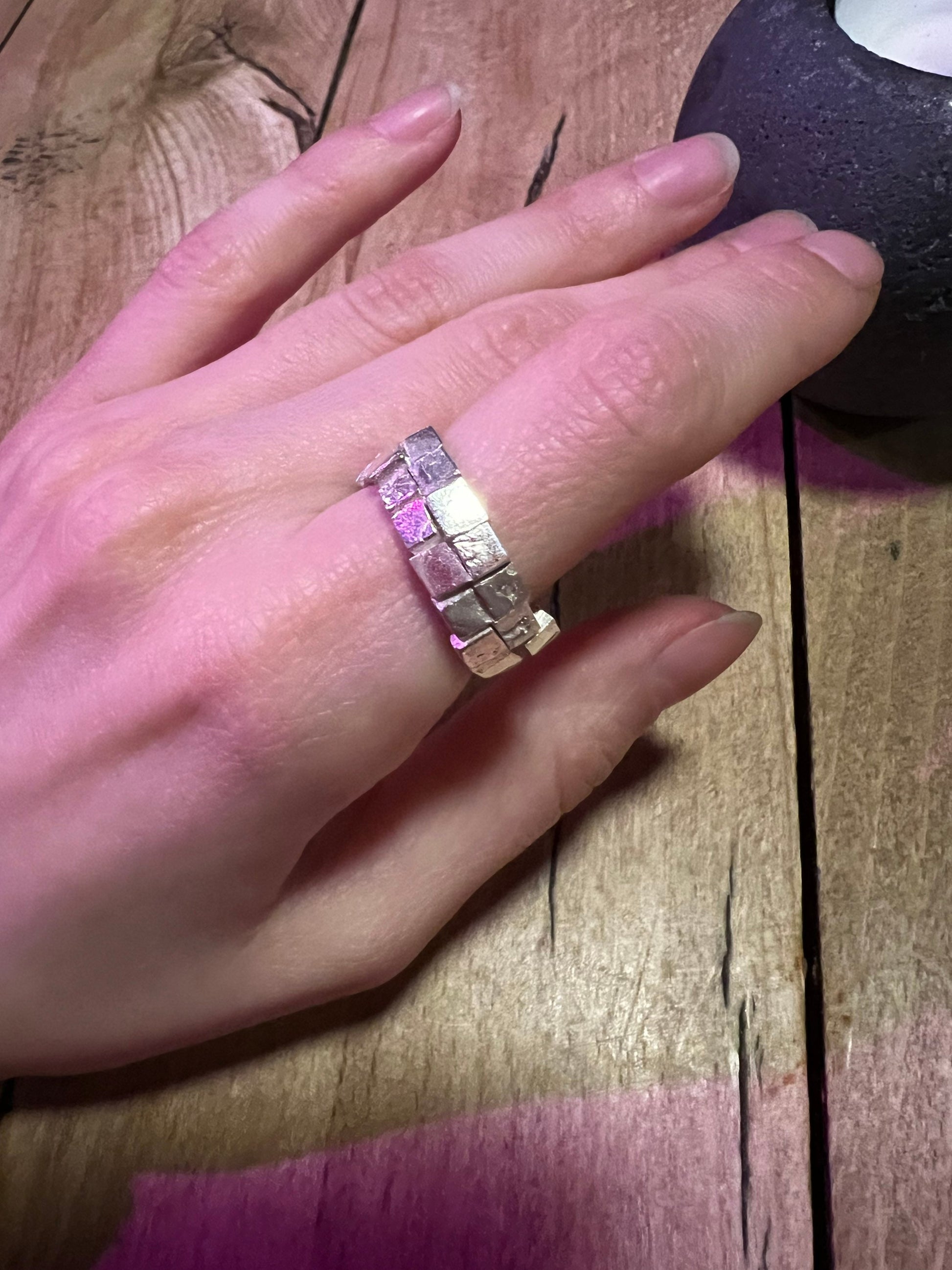 Silver ring on wooden surface – handmade geometric jewelry