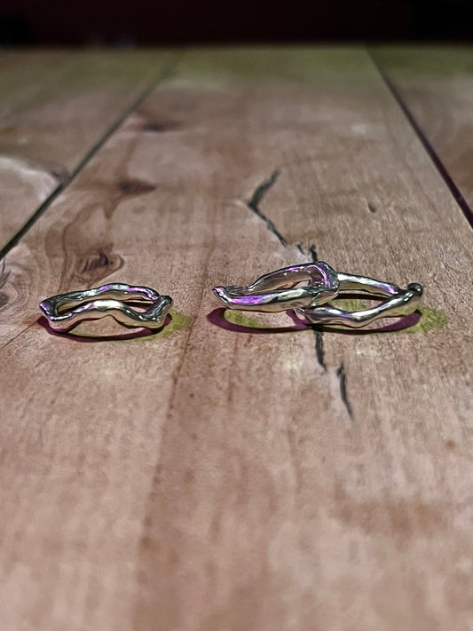 925 sterling silver wave ring set on wooden background, molten liquid metal design