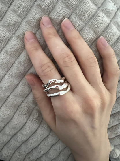 Silver wave ring stack on hand, liquid metal modern jewelry
