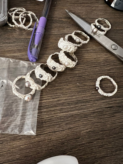 Process of handmade silver pearl rings, jewelry making workspace