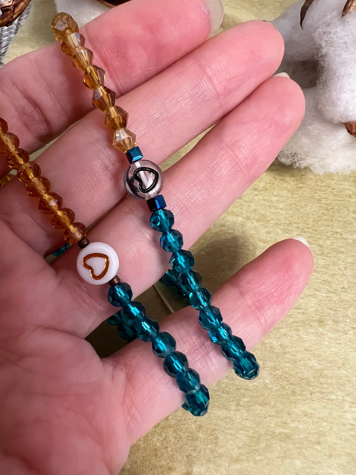 Two handmade glass bead bracelets with heart charm