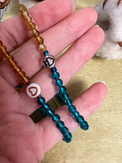 Two handmade glass bead bracelets with heart charm
