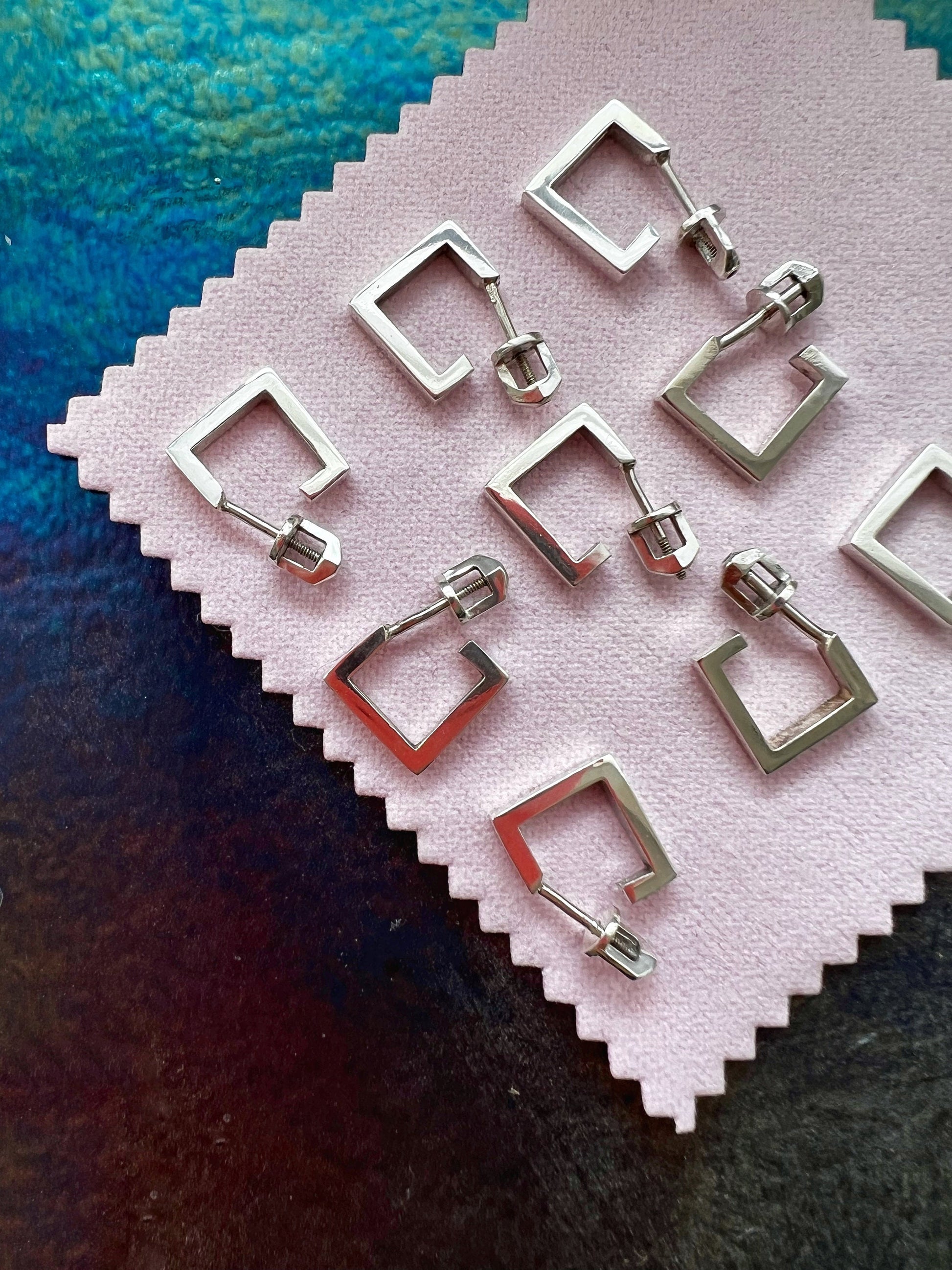 Handmade unisex silver jewelry in minimalist artistic composition.