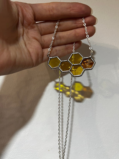 Bee inspired honeycomb necklace glowing in sunlight