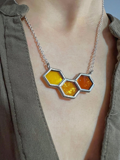 Bee inspired honeycomb necklace worn on neck