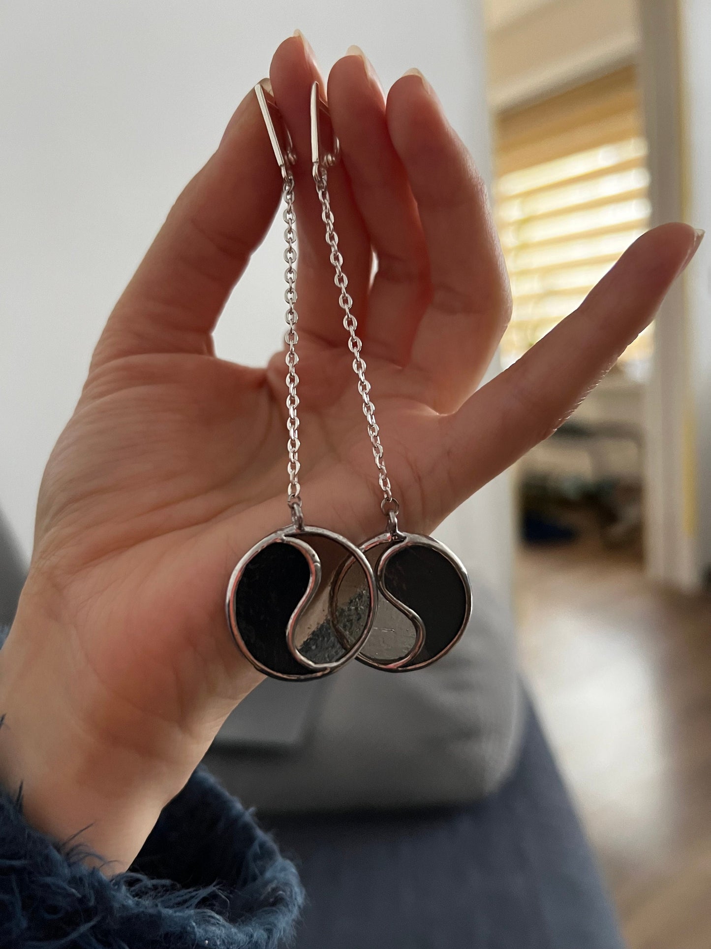 Minimalist Yin Yang earrings worn on neck side view