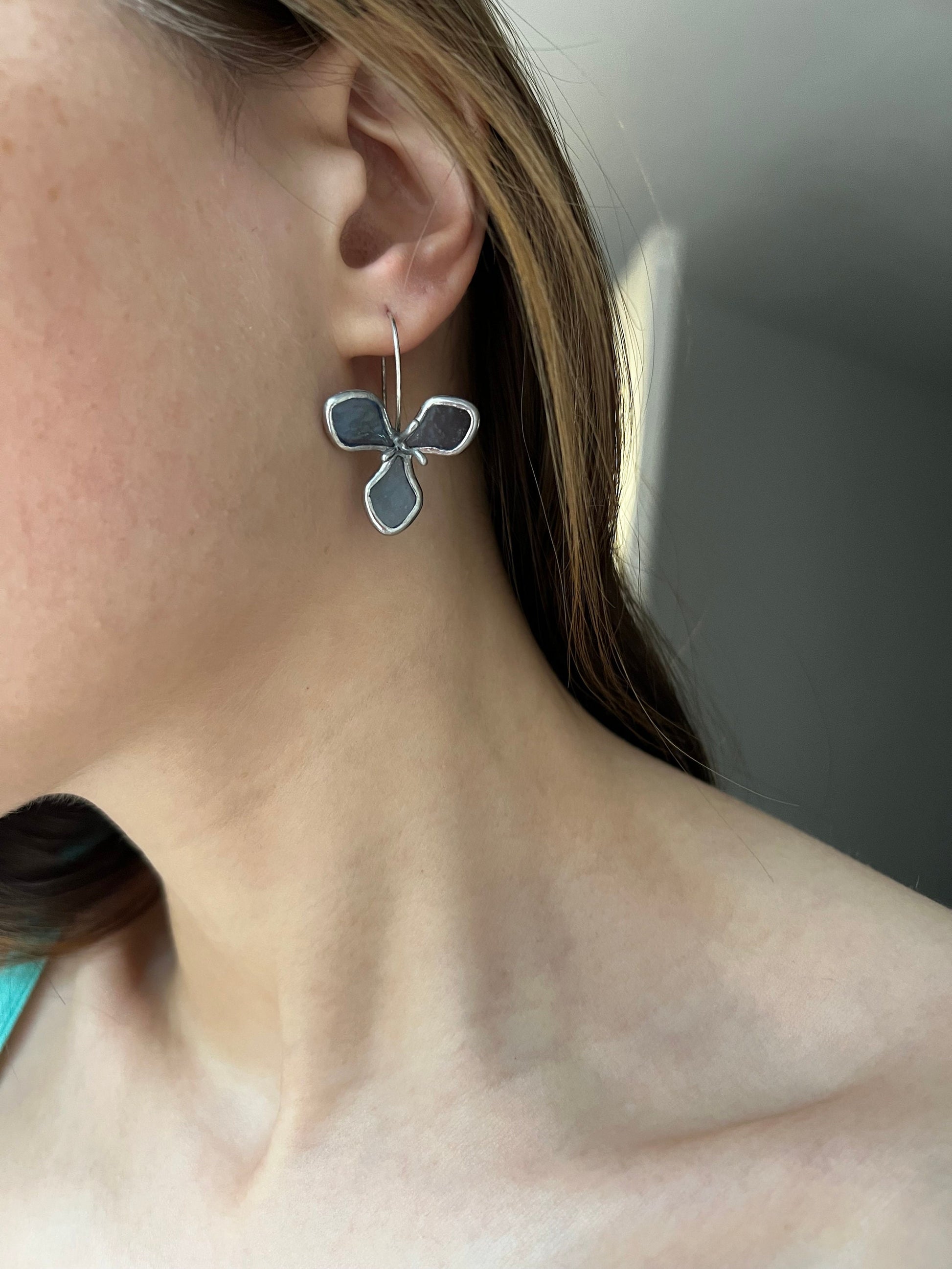 Three-petal stained glass earrings worn by model
