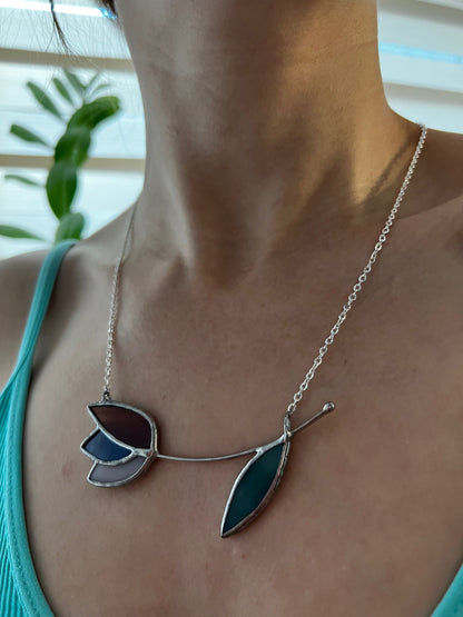 Purple and blue stained glass tulip necklace with green leaf. Colorful floral pendant on silver chain, unique design.