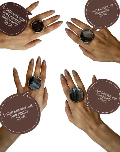 black and silver statement rings on model