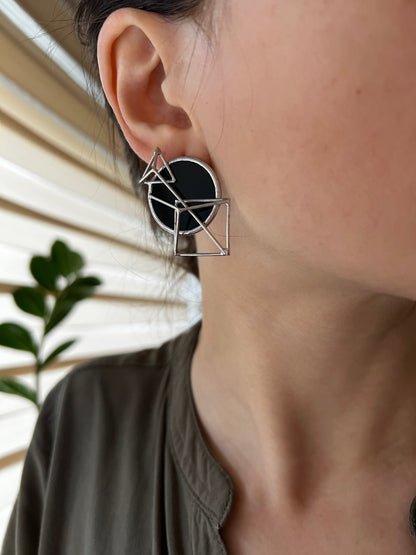 Bold black architectural earrings with circle and triangular elements