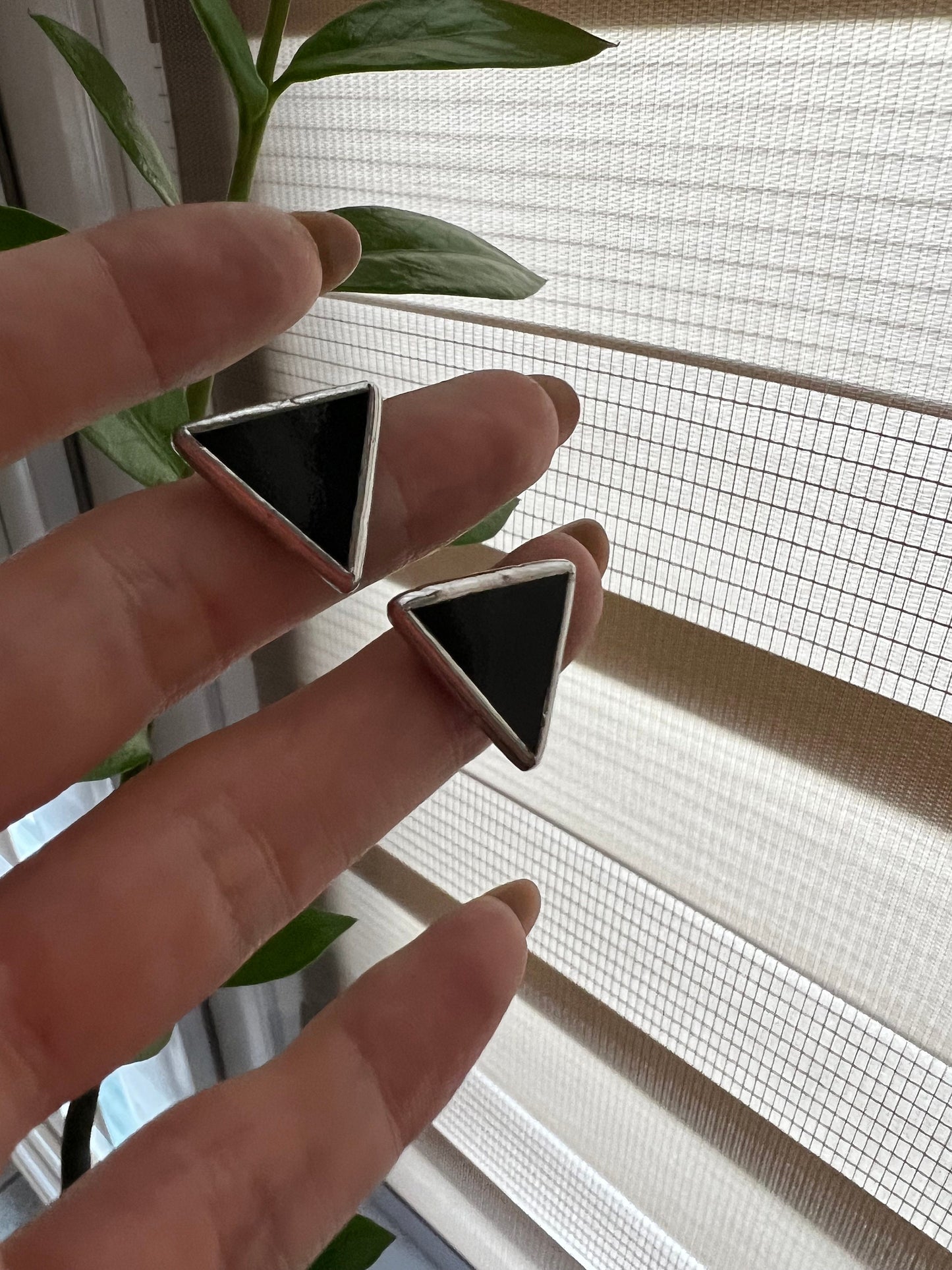 Handmade black and white triangle earrings close up stained glass
