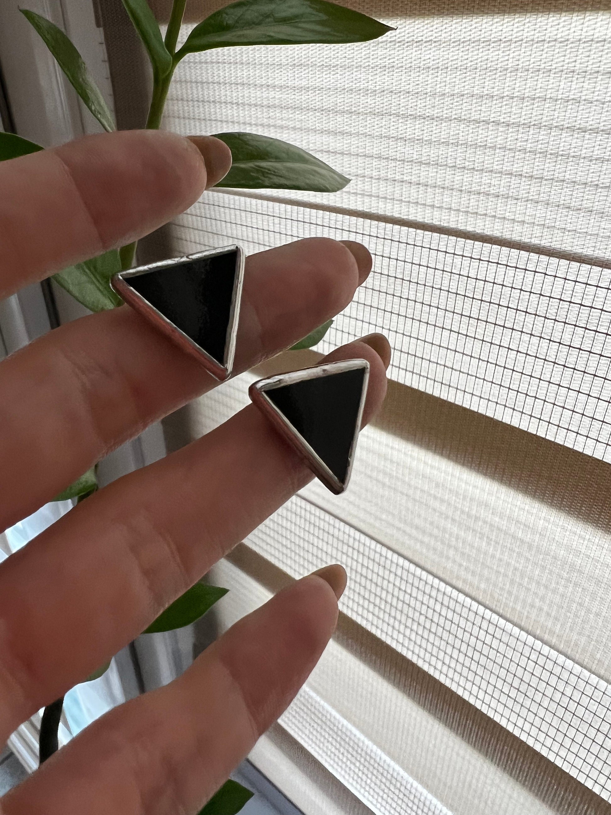 Handmade black and white triangle earrings close up stained glass