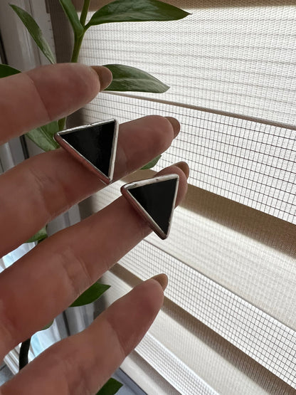 Handmade black and white triangle earrings close up stained glass