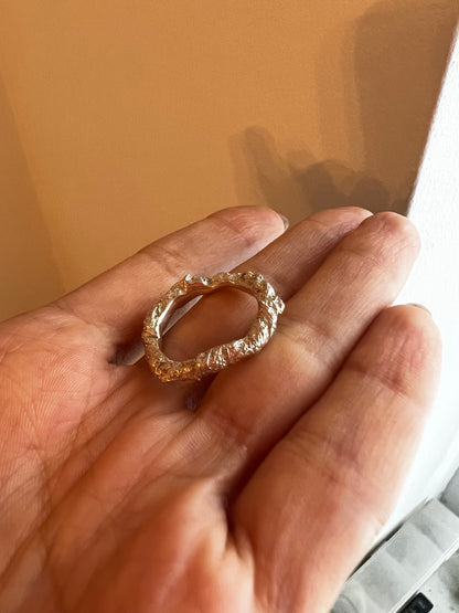 Ring on hand close-up — Raw silver crumpled ring for women, mountain relief inspired jewelry.