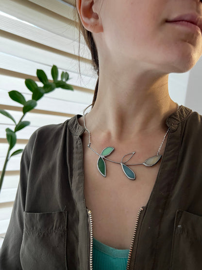 Ocean-inspired stained glass necklace with turquoise, teal and mint leaves, bright botanical charm with coastal colors.