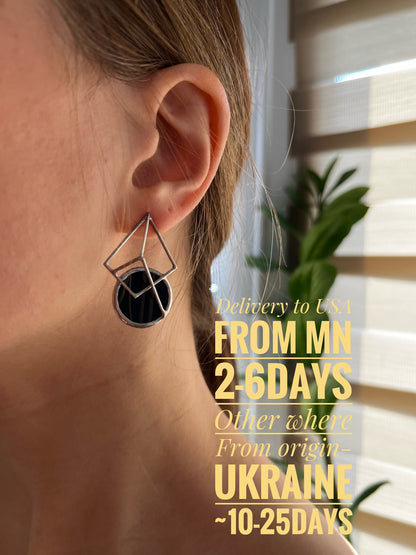 Woman wearing black stained glass geometric stud earrings