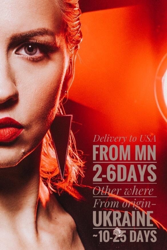 Bold black geometric earrings worn by model with red light accent.