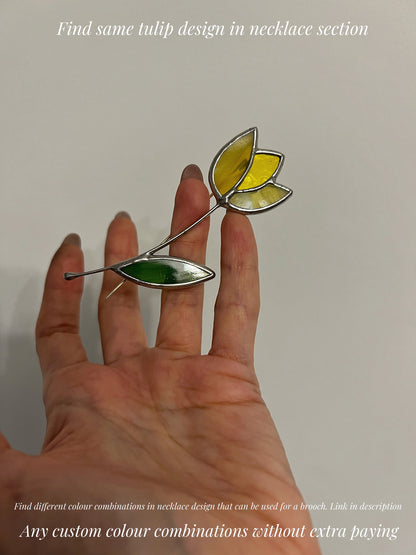 Yellow stained glass tulip brooch displayed on hand lightweight floral glass jewelry